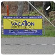 Roadside sign promoting Community-Wide Vacation Bible School in Logansport